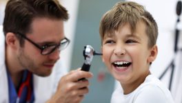 close-up-of-male-doctor-examining-boy-s-ear-with-a-2022-05-20-15-33-00-utc.jpg