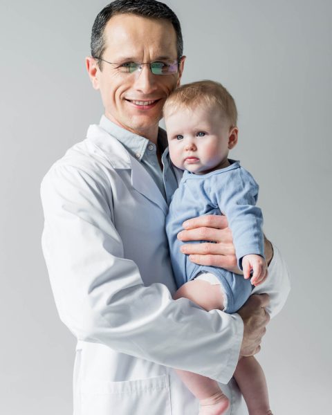 handsome-adult-pediatrician-holding-little-baby-an-2022-12-16-21-09-27-utc.jpg