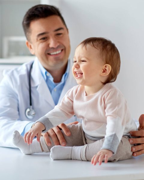 happy-doctor-or-pediatrician-with-baby-at-clinic-2022-12-16-09-45-00-utc.jpg